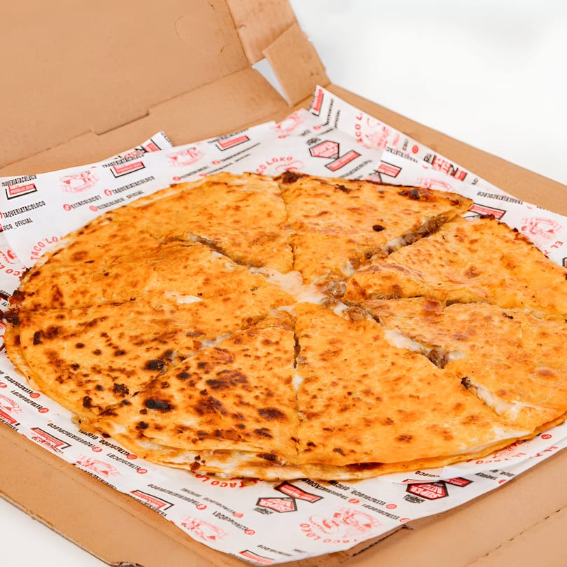 A large, golden-brown quesadilla, sliced into wedges, sits in an El Taco Loko branded box.